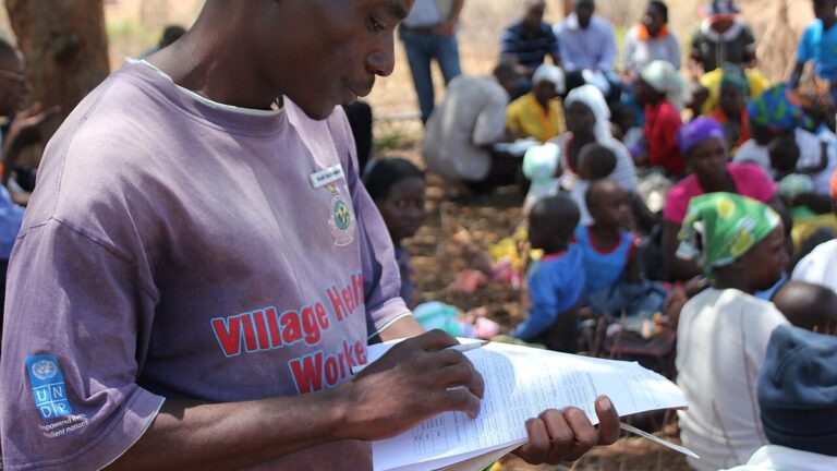 Health worker checking patient records